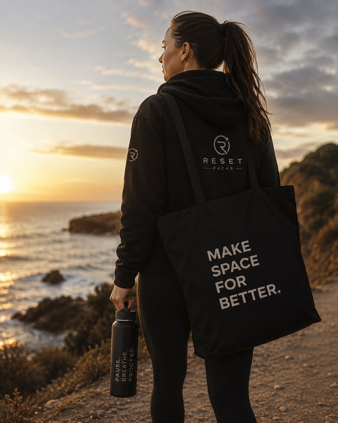Reset Packs lifestyle — woman at cliff with tote and bottle